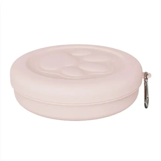 Portable outdoor dog food and water bowl with attached snack box in light pink and green colours.