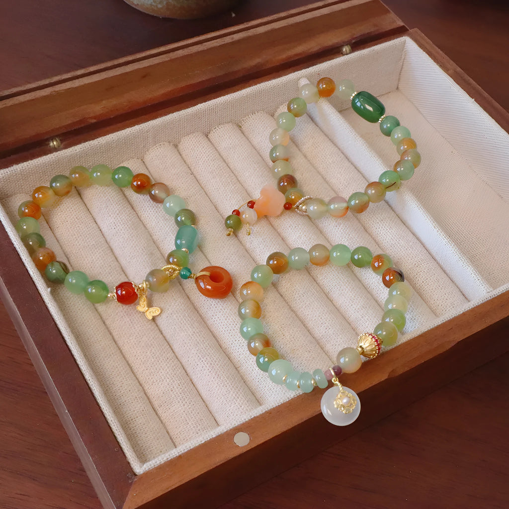 Natural peacock green agate bracelet with 8mm beads and butterfly peace buckle on white background