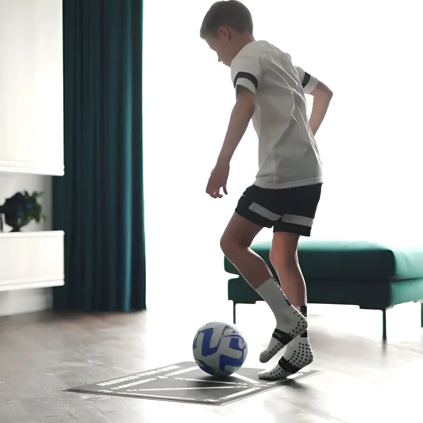 Black football training mat measuring 60 by 90 centimetres with a non-slip rubber base