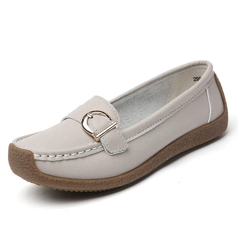 Women's beige loafers with round toe and flat heel on a light background