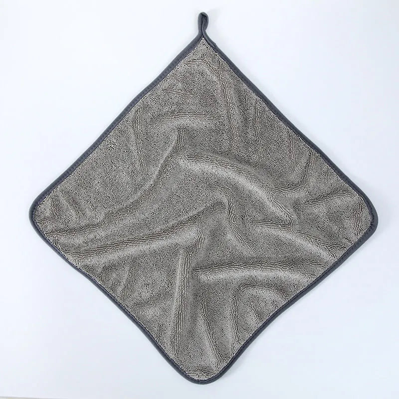 Grey car cleaning towel with red edge trim showing braid twisted texture for automotive glass washing