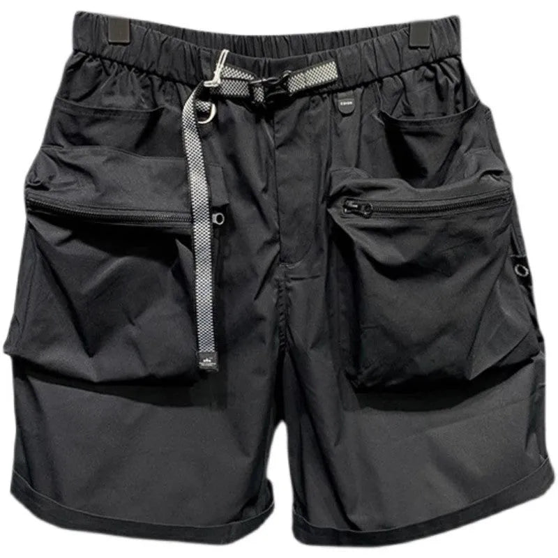 Man wearing loose fit black workwear shorts with pockets, showing above-the-knee length and straight leg style.