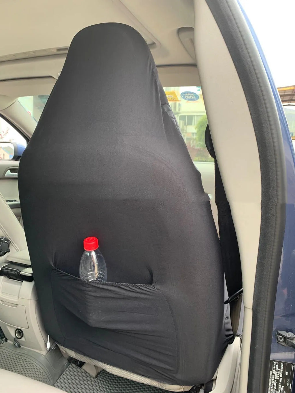 Black quilted automotive seat cover with PU and polyester construction showing plastic hooks
