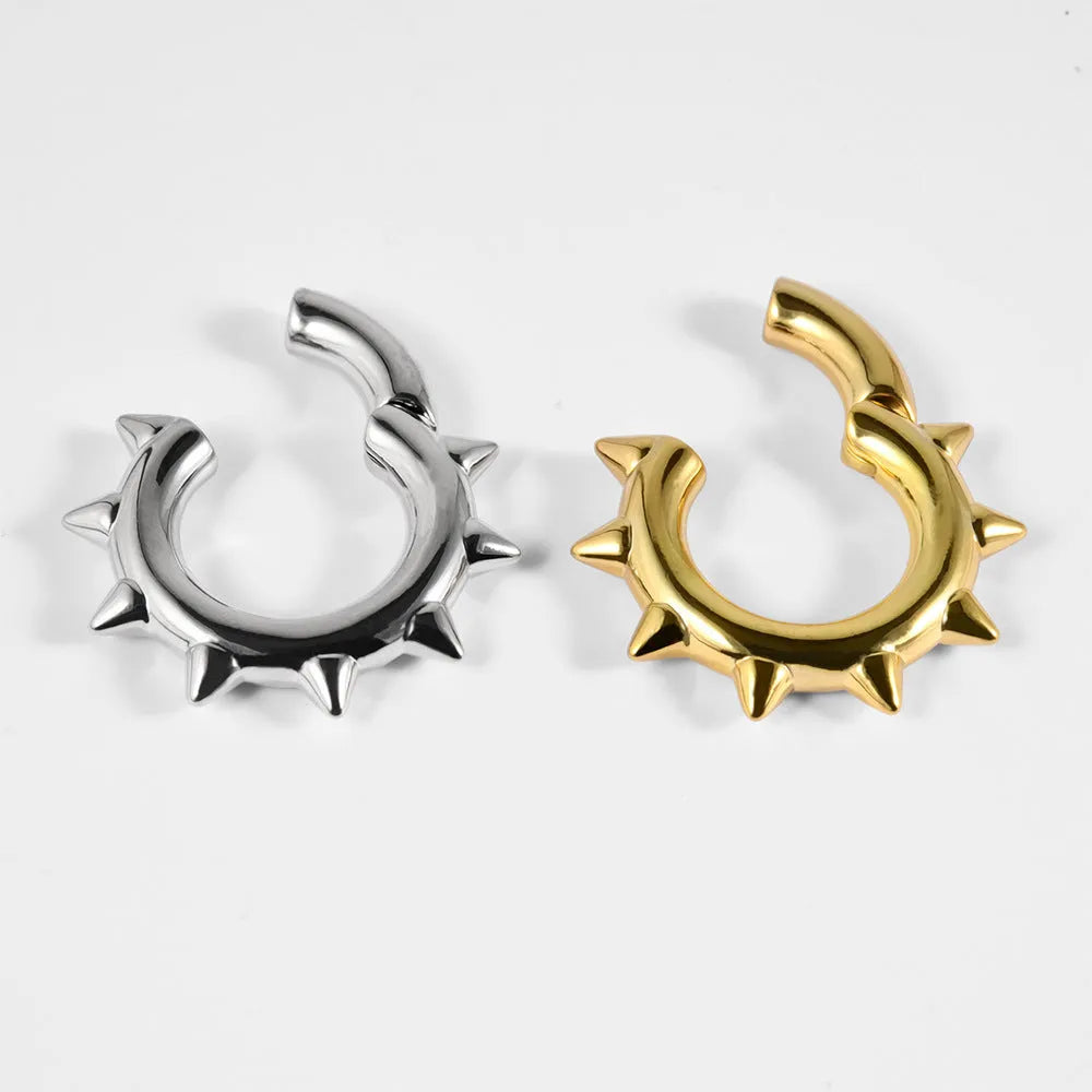 A pair of sharp cone geometric copper ear extenders with round magnet fastenings, shown in one of eight available style colours.