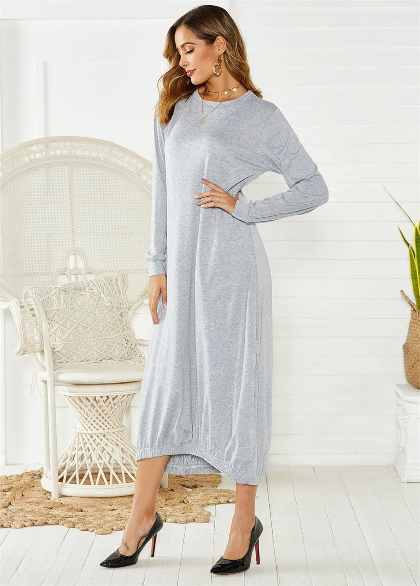 A loose black knitted lantern dress with a lace-up crew neck, showcasing a casual silhouette.