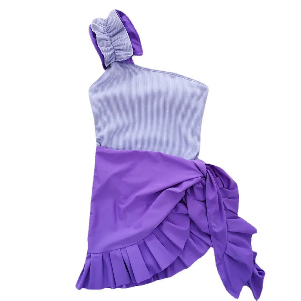 Women's solid colour single-shoulder two-piece swimsuit with high-waist bottoms on a mannequin.