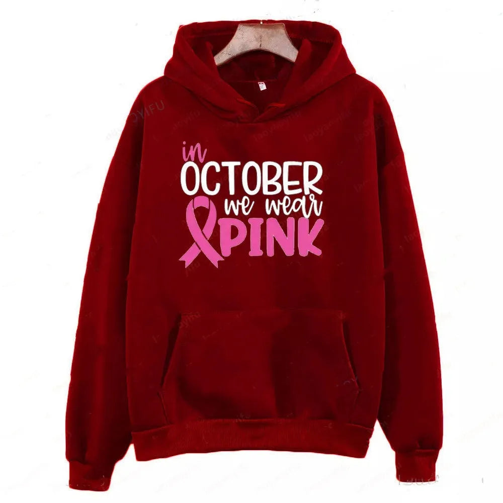 Retro graphic 'I'm A Survivor' slogan pullover hoodie with side seam pockets in pink colour.