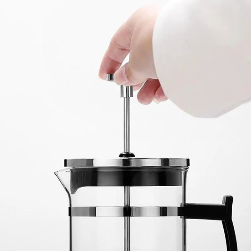 Compact 350ml manual pour-over coffee maker with glass carafe and stainless steel filter.
