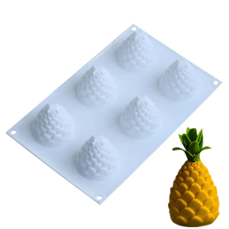 Set of six flexible silicone baking moulds showing pear, pine cone, and pineapple fruit designs.