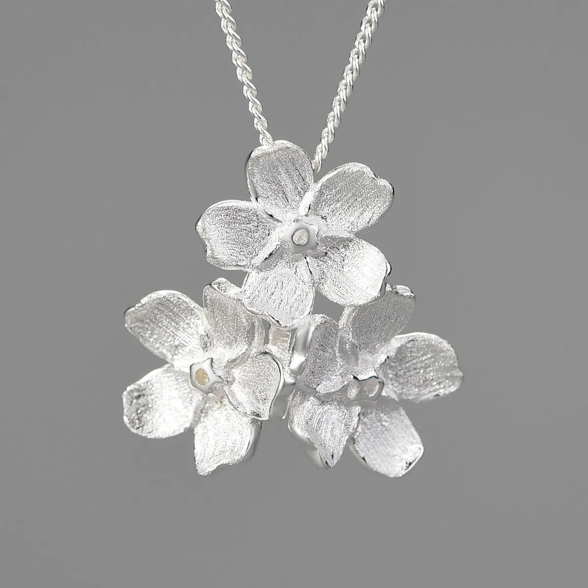 Myosotis Sylvatica sterling silver floral pendant in pastoral style, showing gold and silver colour options.