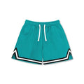 Man wearing loose grey sports shorts made from elastic polyester fabric.