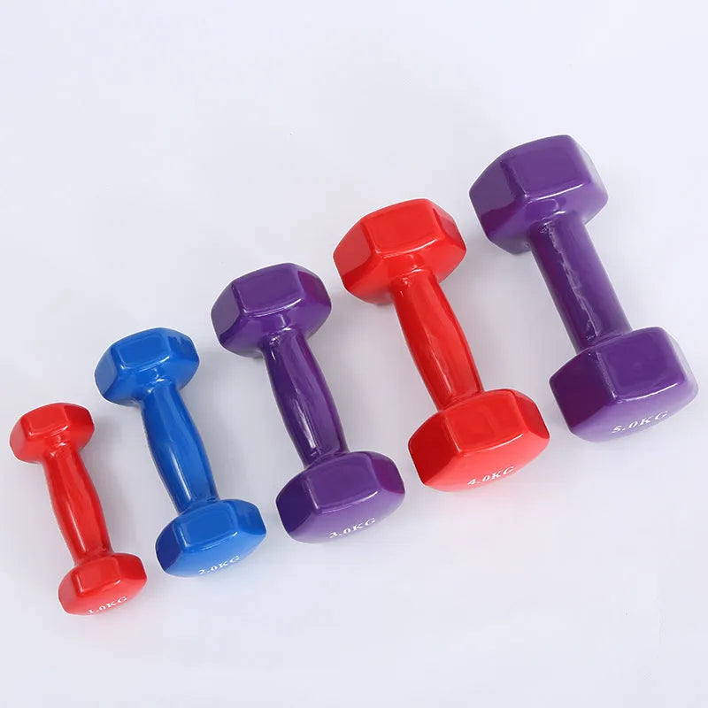 Bright coloured plastic dumbbells in 0.5kg, 1kg and 1.5kg sizes for home fitness with glossy surface