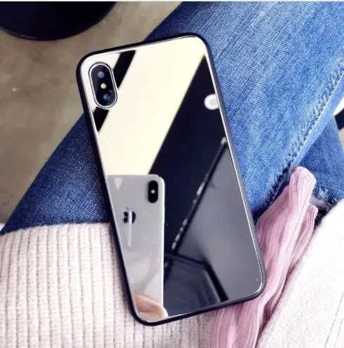 Black mirrored back cover phone case for Apple iPhone models on a table.