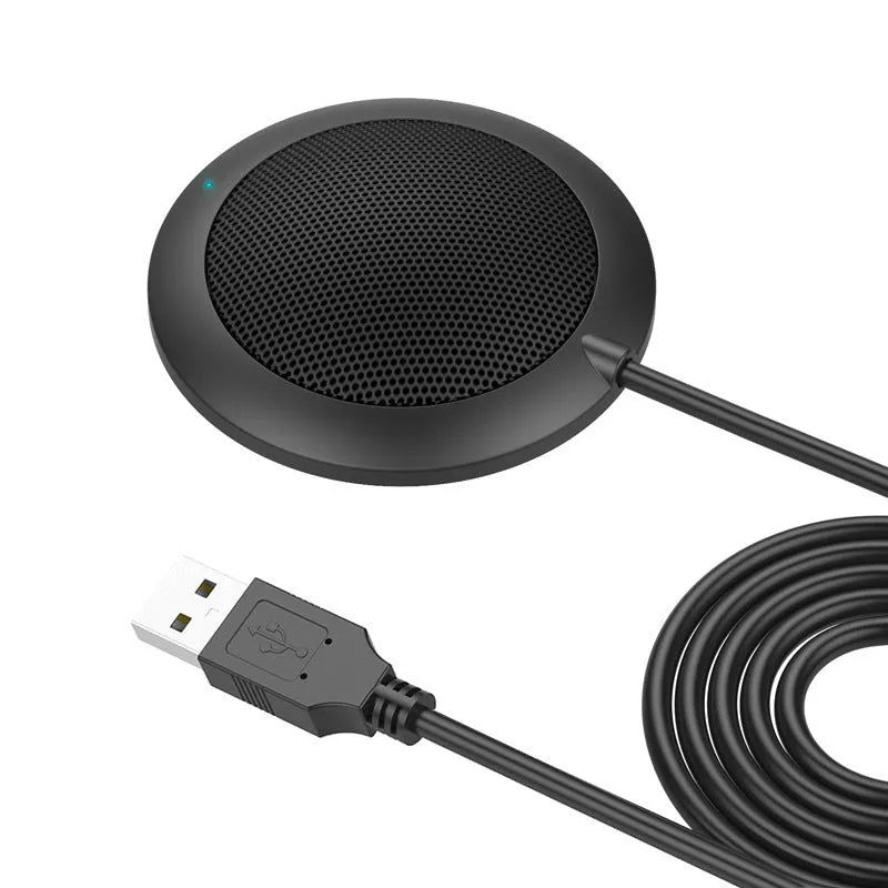 Black circular USB conference microphone with metal mesh grill on a desk