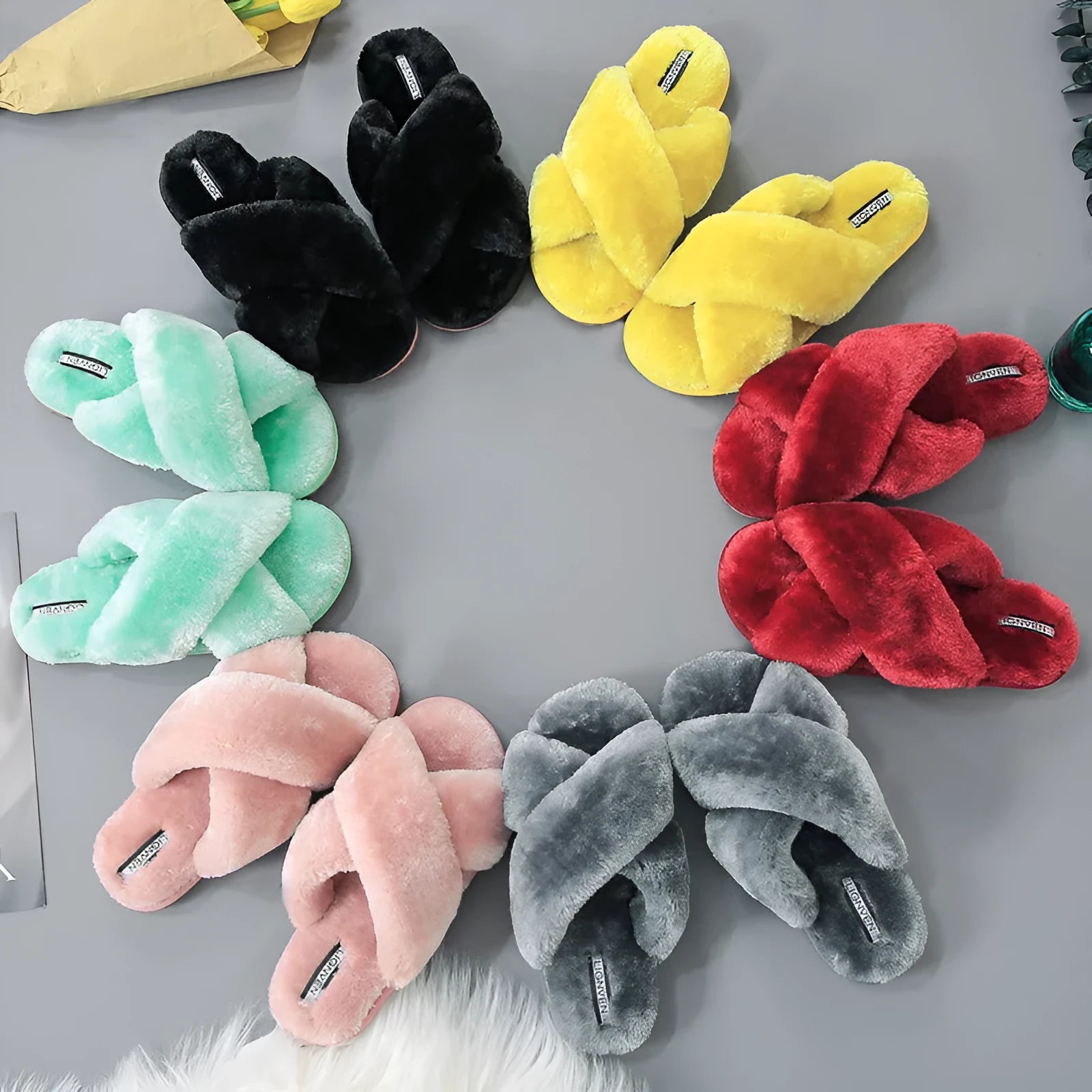Women's cross open-toe fur slippers in black showing non-slip sole pattern