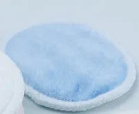 Set of eight pink and blue velvet makeup remover pads next to an organic cotton mesh drawstring bag.