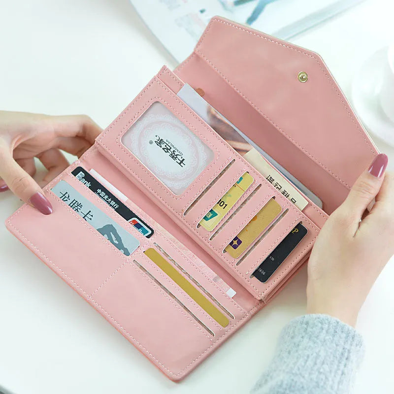 Open trifold women's wallet showing card slots and buckle closure in one of five colours.