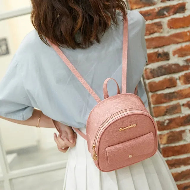 Compact black PU women's shoulder bag also worn as a small backpack, showing zipper closure.