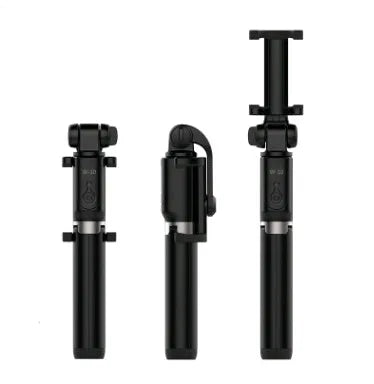 Aluminium Bluetooth selfie stick with tripod base and remote control next to a mobile phone.