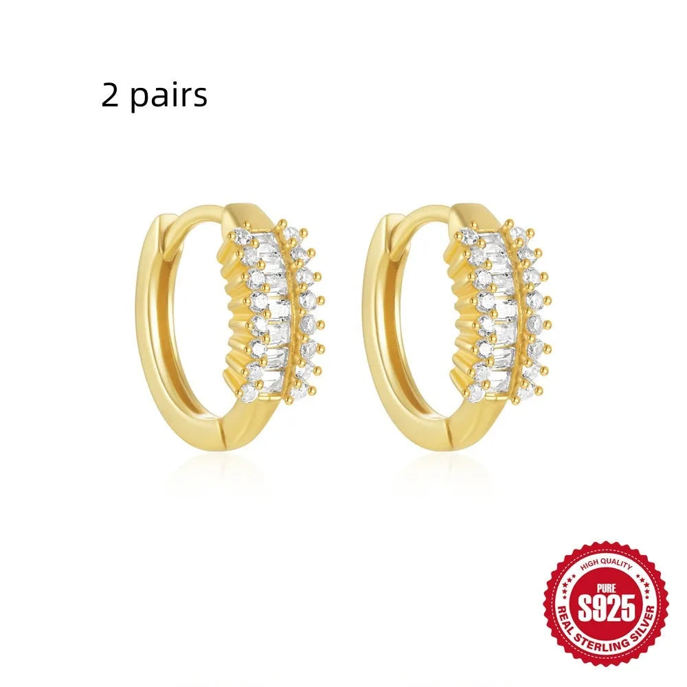 Sterling silver geometric stud earrings with small round design elements in gold or silver finish