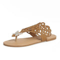 Women's black slip-on sandals with rhinestone decoration on the flip-toe and a flat rubber sole.