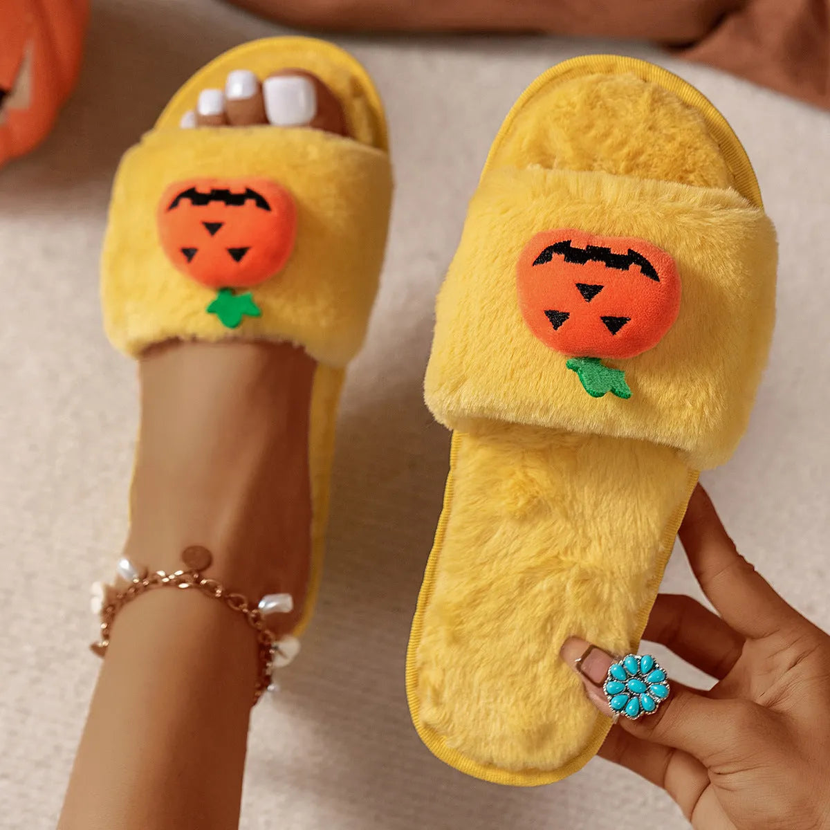 Women's Halloween pumpkin plush slippers in white and yellow with synthetic fur upper