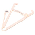 Transparent acrylic body fat caliper with measurement scale on a white background.