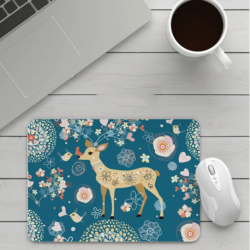 Custom cartoon thickening mouse pad on a desk, showing a colourful design with black stitched edge.