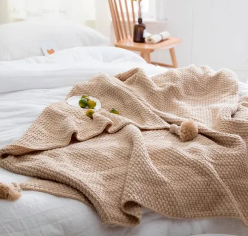Nordic fringe knit ball blanket in beige colour on sofa, showing 130×170cm dimensions and fringe detailing.
