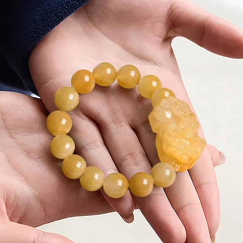 Carved Jinsi Jade money bracelet in golden thread colour showing large and small size options.
