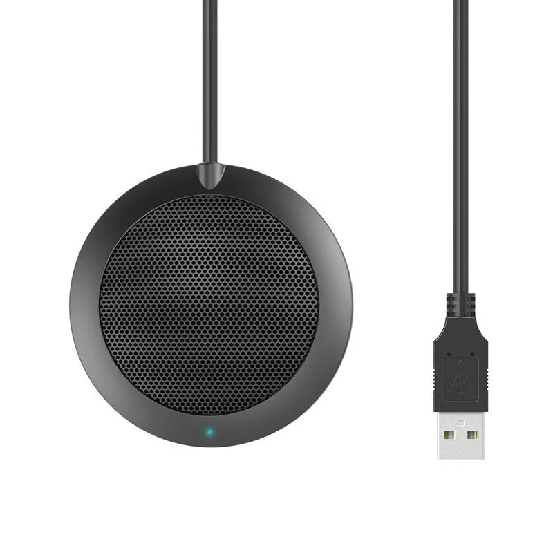 Black circular USB conference microphone with metal mesh grill on a desk