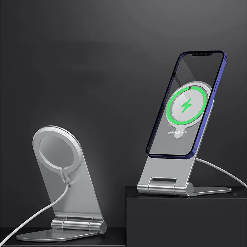 Silver vertical adjustable magnetic phone bracket for iPhone 12 series on a desk.