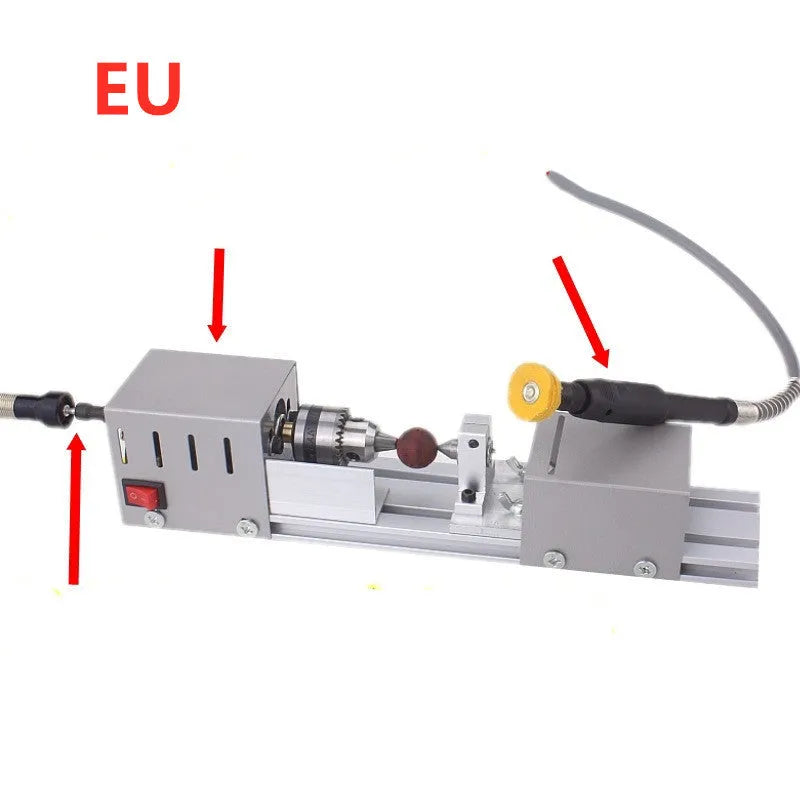 Mini silver metal woodworking lathe with carving knives on benchtop for small-scale turning projects