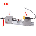 Mini silver metal woodworking lathe with carving knives on benchtop for small-scale turning projects