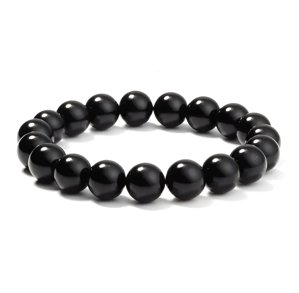 A geometric black onyx bracelet for women with 8mm beads on an elastic cord.