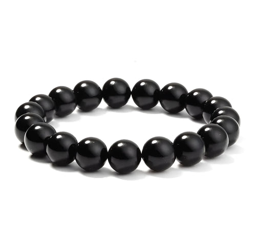A geometric black onyx bracelet for women with 8mm beads on an elastic cord.