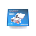 NES retro game console with two controllers, power supply, and AV cable on dark surface