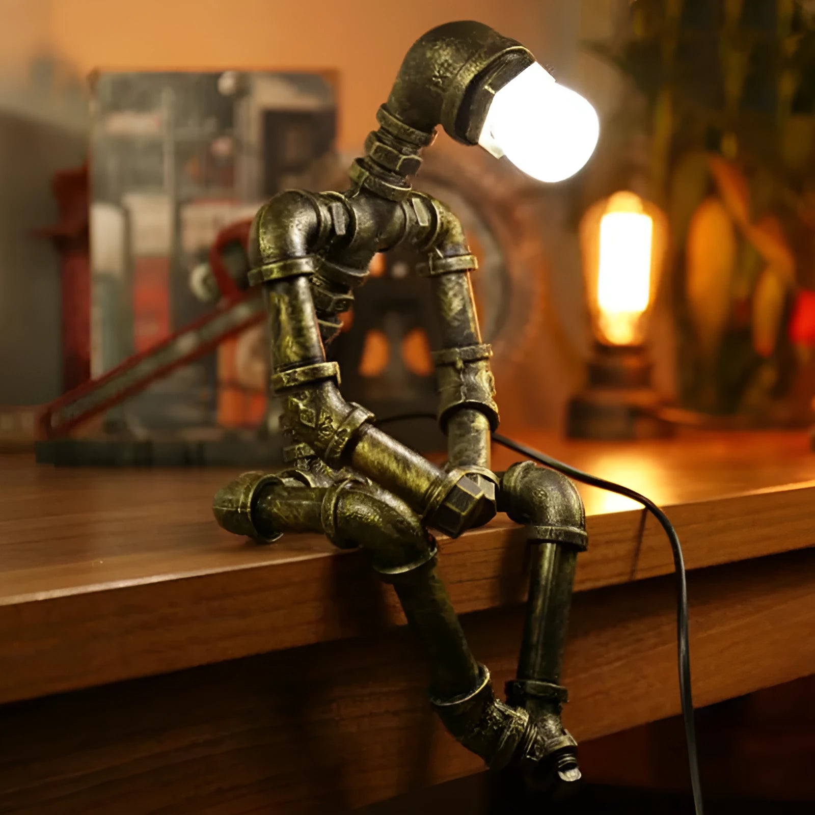 Green bronze vintage robot table lamp with industrial iron pipe design on wooden desk