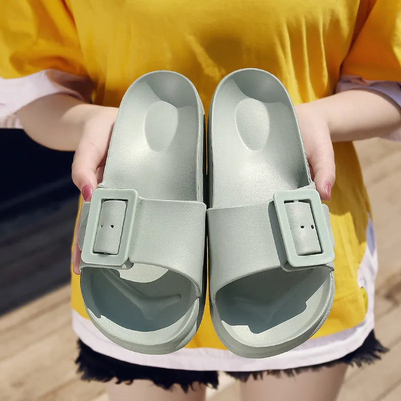 Women's grey blue EVA flip-flops with a buckle strap on a soft sole.