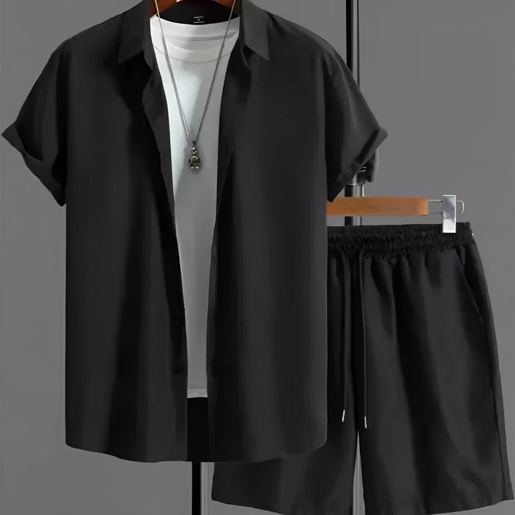 Man wearing a grey jacquard short-sleeve suit jacket and matching shorts.