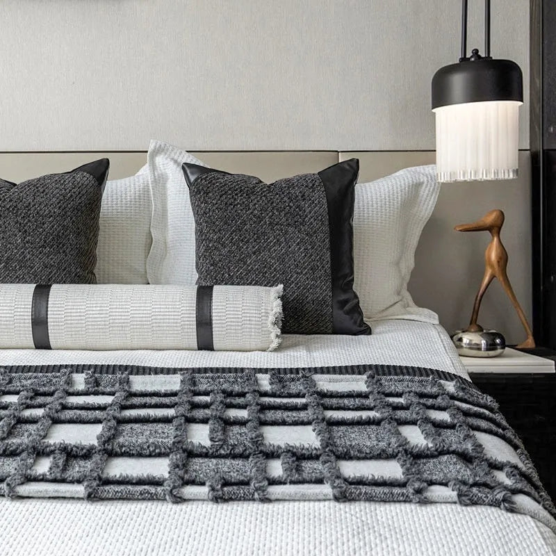 Modern minimalist grey and white plaid bed runner blanket set with matching pillow on a double bed