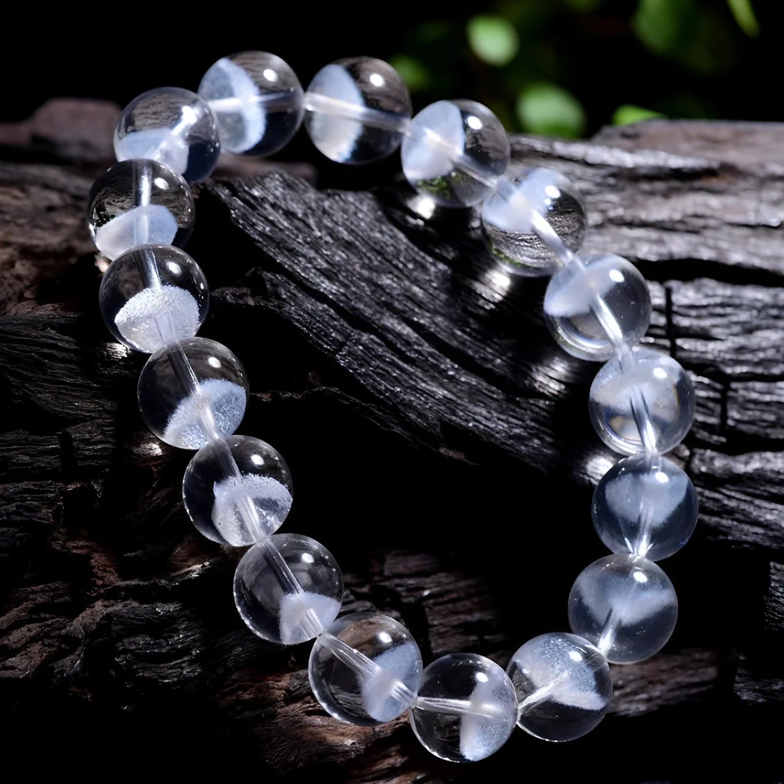 Women's white crystal ghost pyramid bracelet with Ruyi symbol on wrist, showing bead detail.