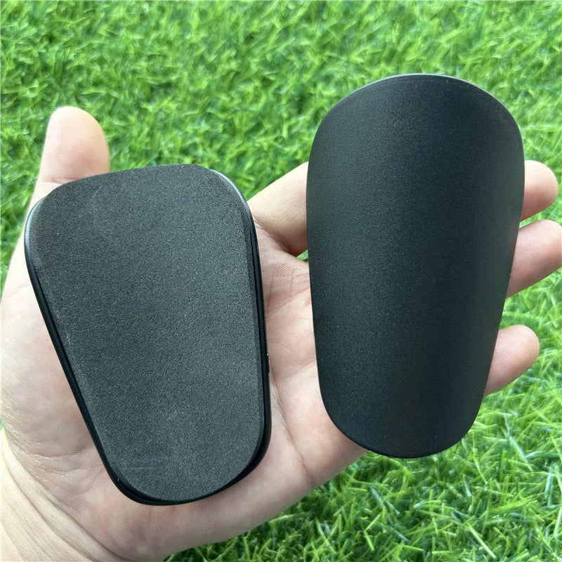 Extra small mini football shin guards plastic protection 8x5 cm black white youth