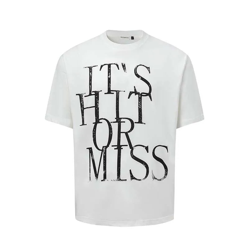 Man wearing a blue loose-fit T-shirt with a large white American retro style letter print on the front.
