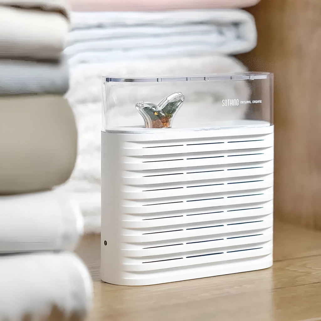 White reusable electric cabinet dehumidifier box with transparent geometric top showing orange silica gel beads inside.