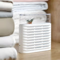 White reusable electric cabinet dehumidifier box with transparent geometric top showing orange silica gel beads inside.
