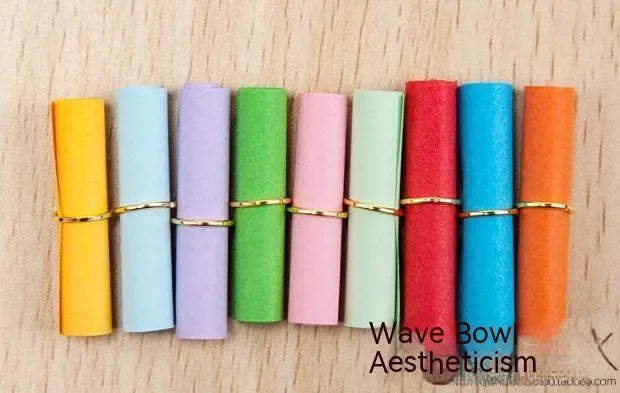 Assorted colourful scroll-style paper notes with metal eyelets in four different sizes.
