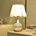 Gold crystal desk lamp with iron art base and remote control on wooden table