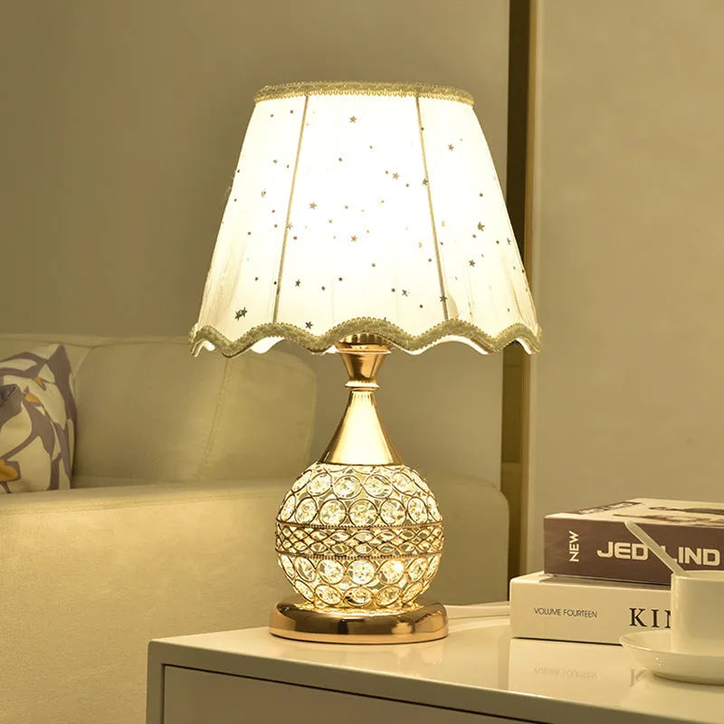 Gold crystal desk lamp with iron art base and remote control on wooden table