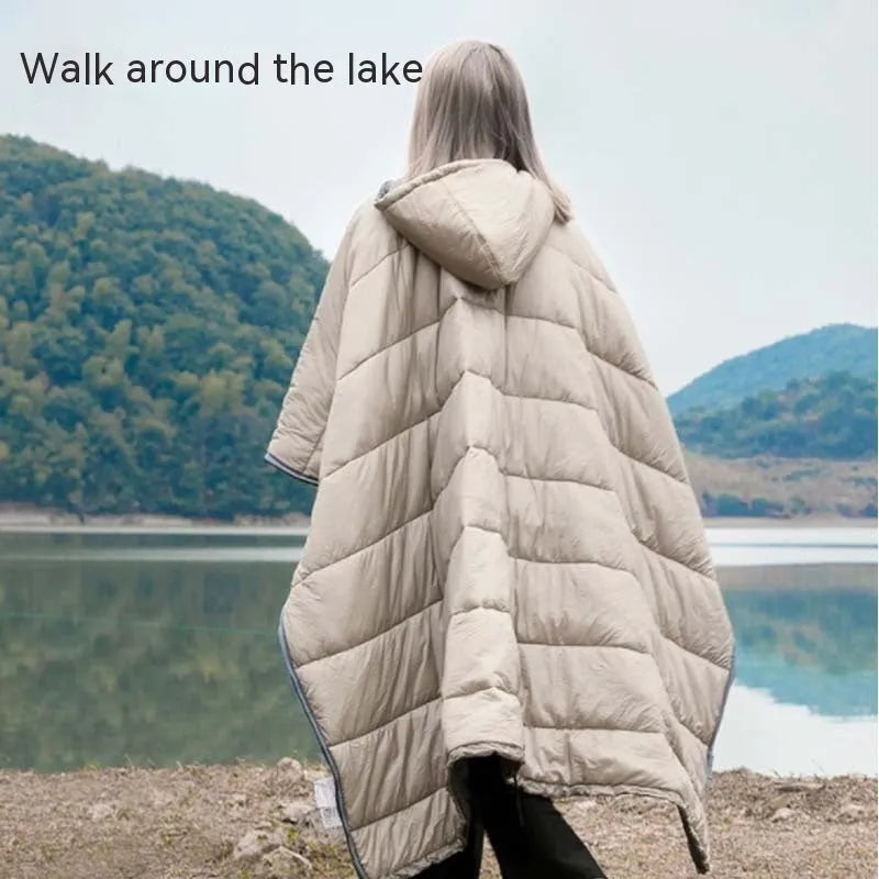 Grey adult-sized outdoor cloak sleeping bag worn as a cape, showing its 200x140cm dimensions.